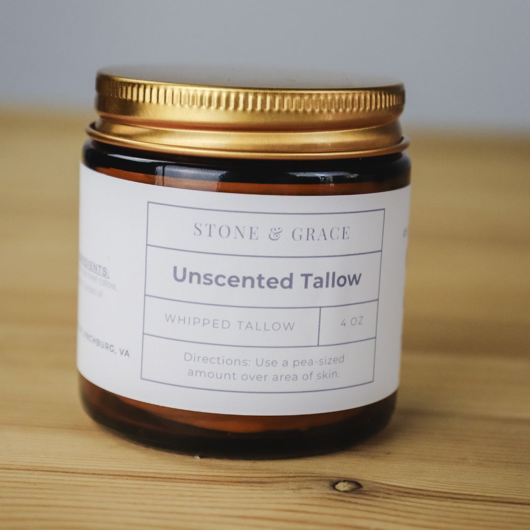 Jar of Stone & Grace Unscented Tallow on a wooden surface
