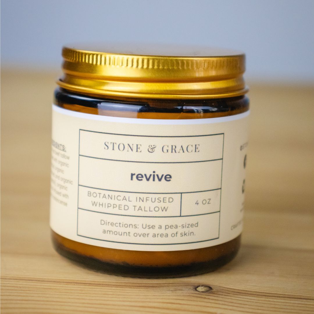 Jar of 'revive' by Stone & Grace on a wooden surface with a light blue background