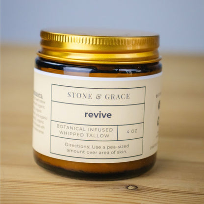 Jar of 'revive' by Stone & Grace on a wooden surface with a light blue background