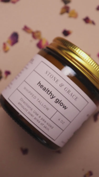 Short video featuring rose petals, a whisk, a brick of tallow and a jar of healthy glow whipped tallow.